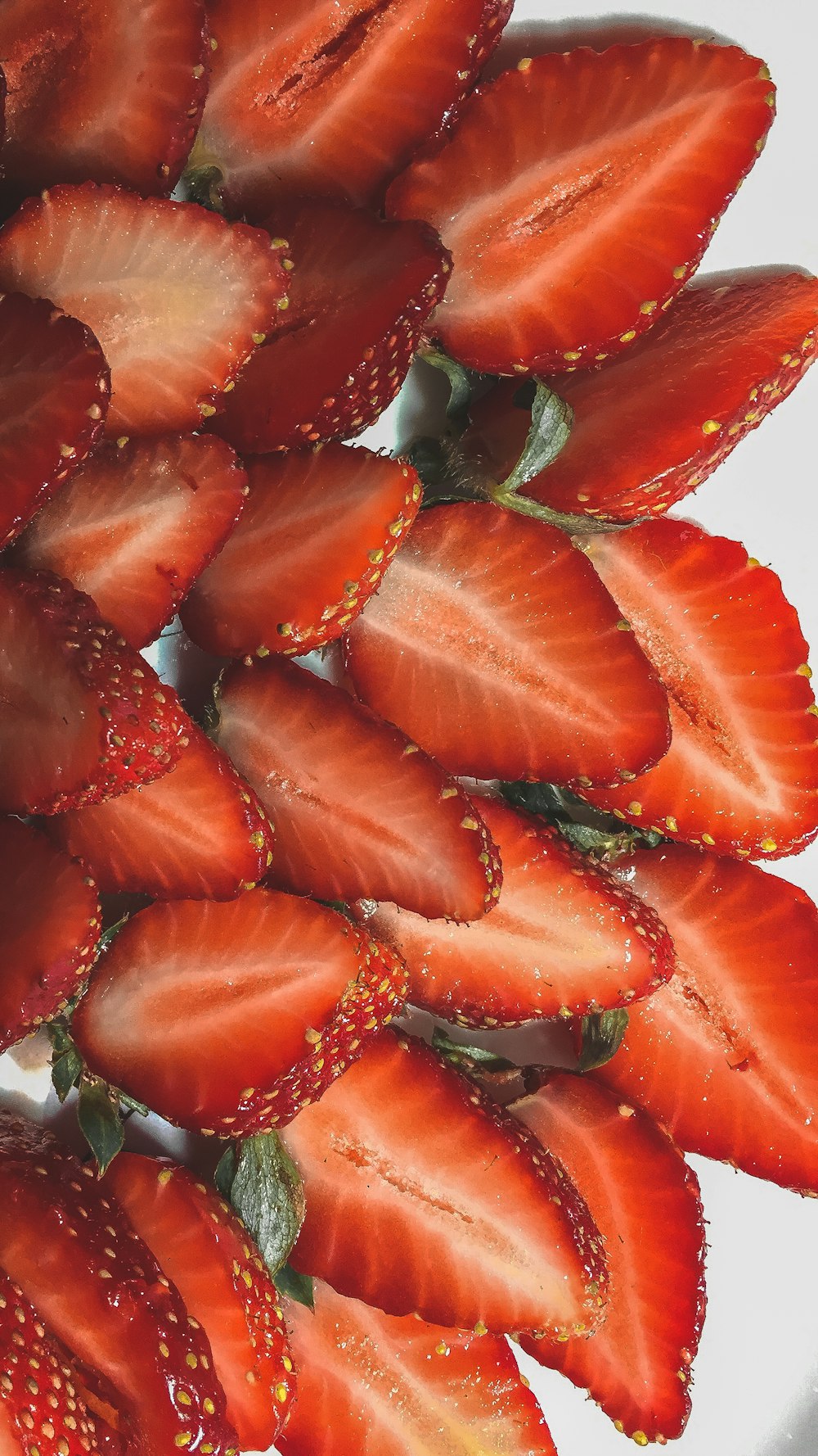 sliced strawberries in white ceramic plate