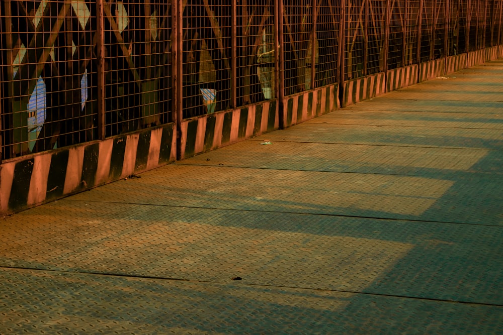 brown wooden bridge with red metal fence