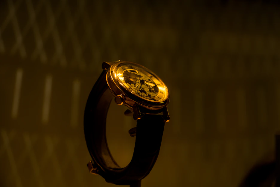 A close-up of an elegant ladies' watch with a delicate leather strap resting on a soft fabric background.
