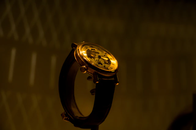 Close-up of an elegant wristwatch with intricate details and a leather strap.