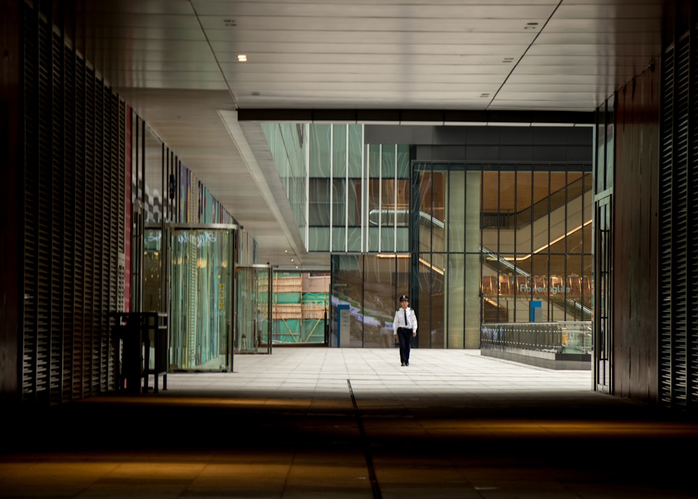 man in black jacket walking on hallway