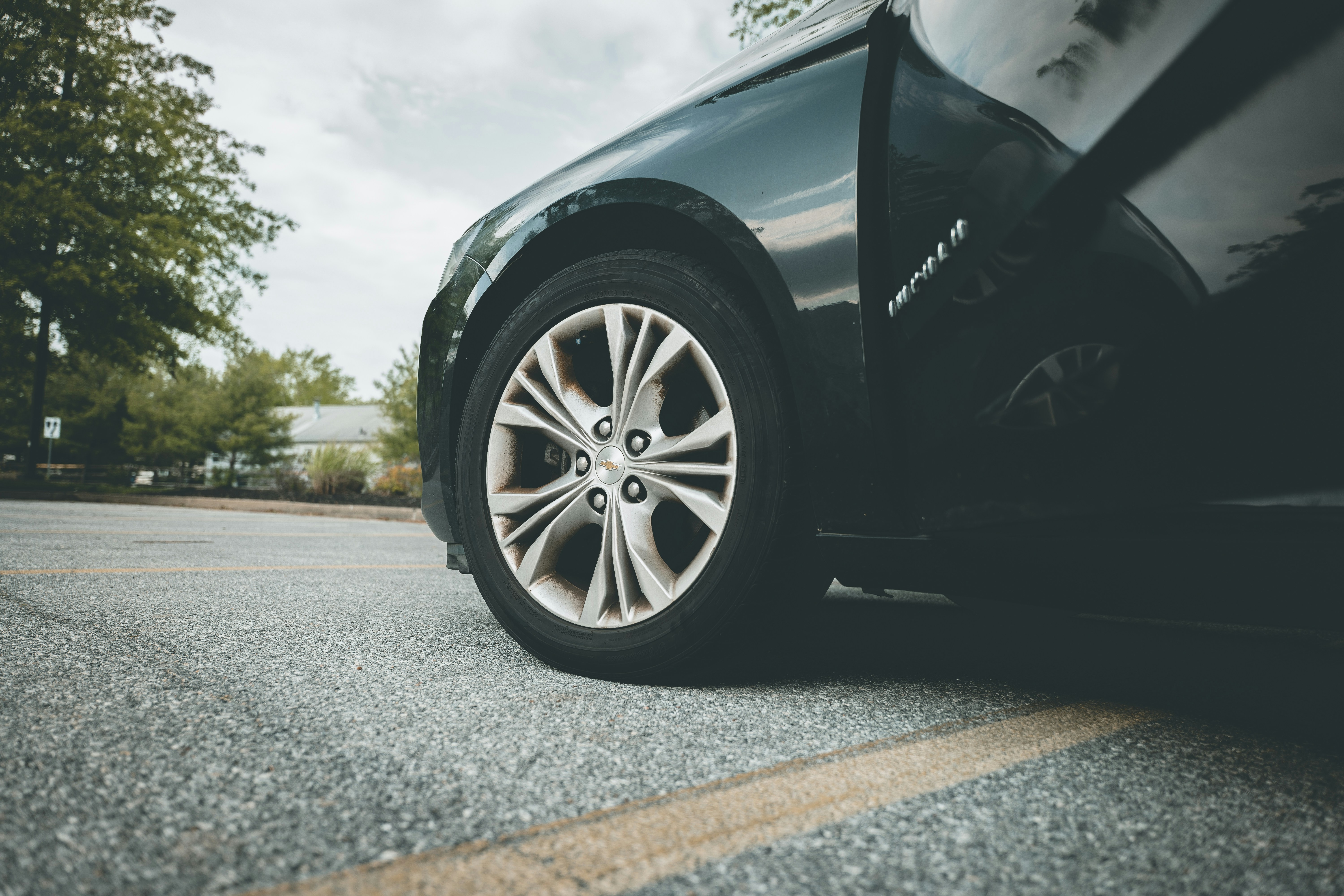 black car on gray asphalt road during daytime