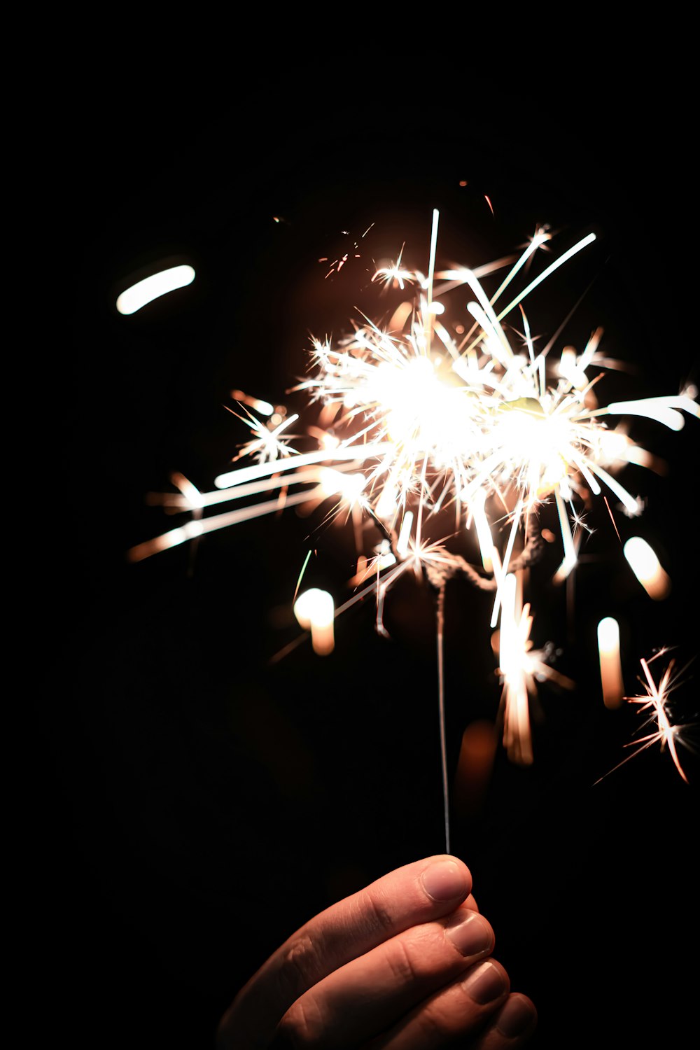 white and yellow fireworks in dark room