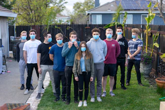 group of people standing on green grass field during daytime