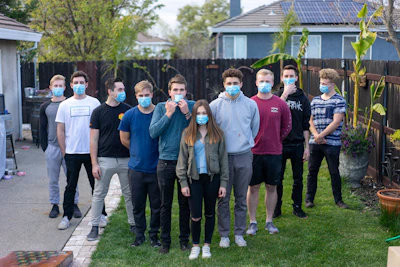 group of people standing on green grass field during daytime