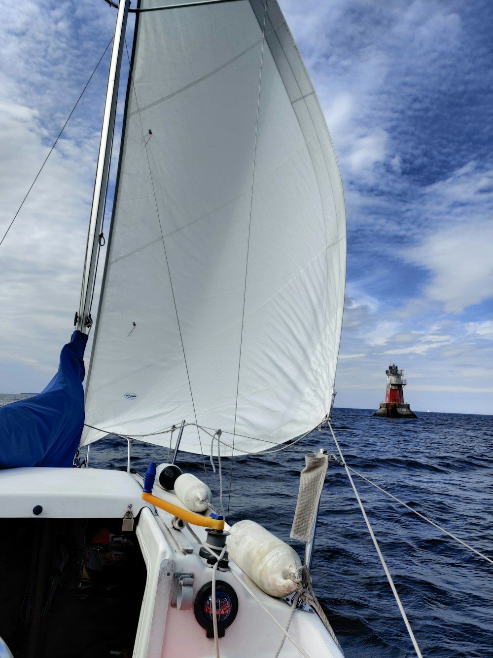 white sail boat on sea during daytime