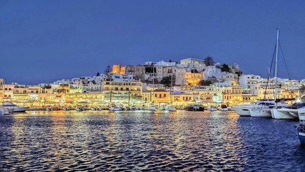 City buildings near body of water during night time — Naxos, Greece