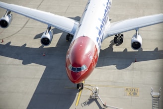 white and red airplane on airport during daytime