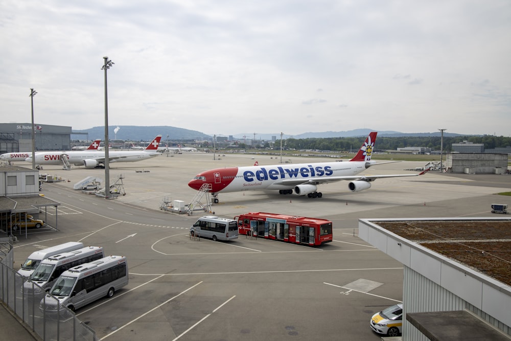 white and red passenger plane on airport during daytime