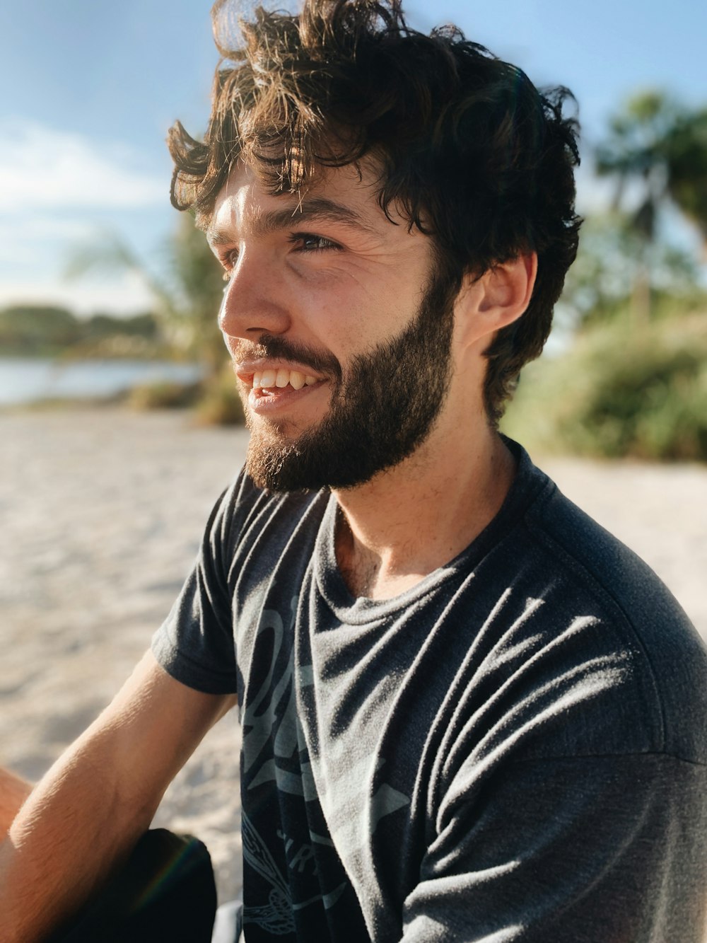 man in black and white crew neck t-shirt smiling