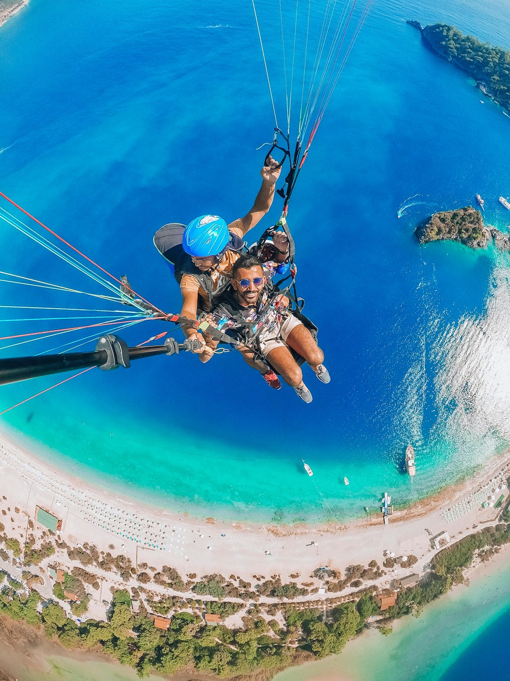 uomo in casco blu che cavalca sul paracadute blu e bianco