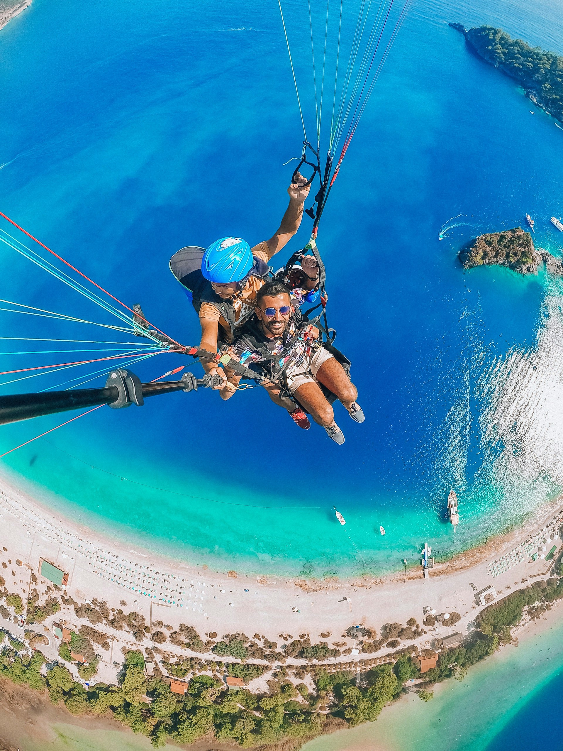 man in blue helmet riding on blue and white parachute