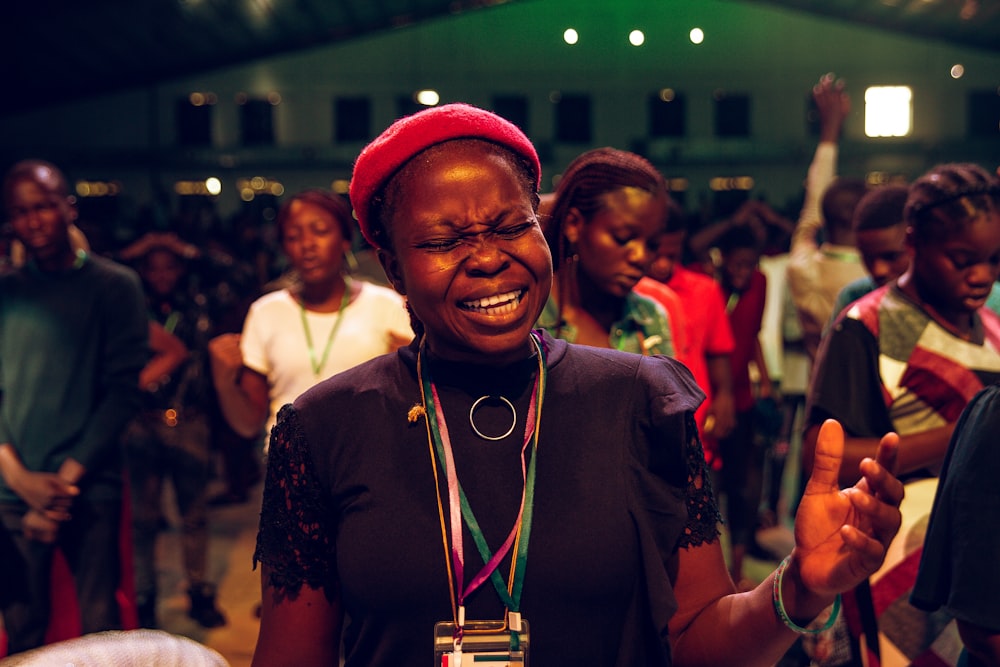 smiling woman in black shirt wearing red hat