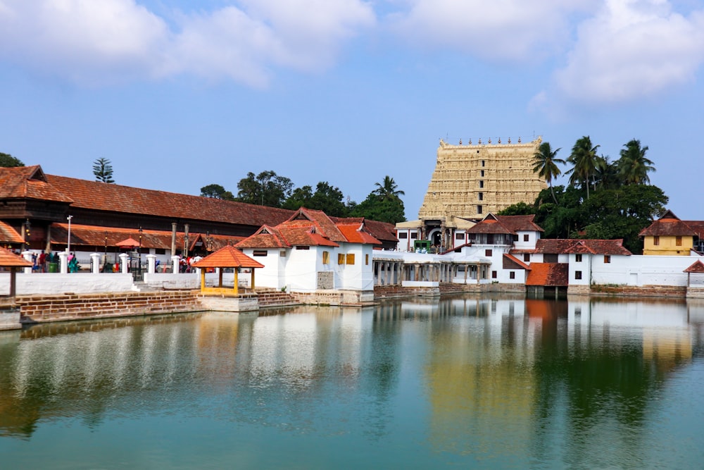 brown and white concrete building near body of water during daytime