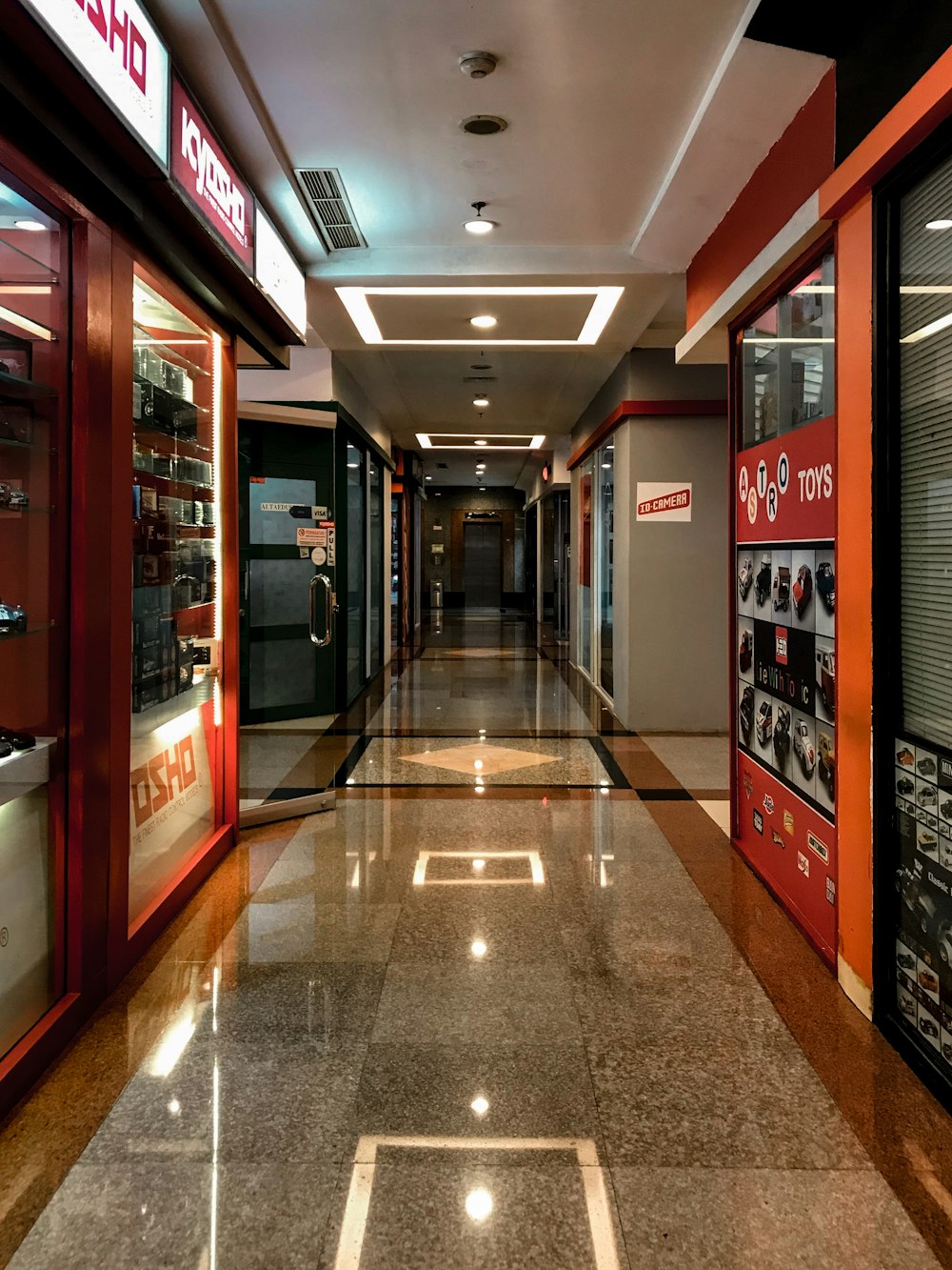 brown and white hallway with glass doors