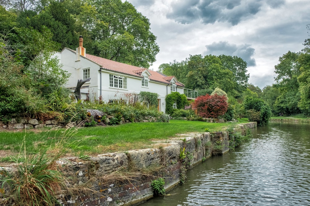 white and brown concrete house beside river during daytime