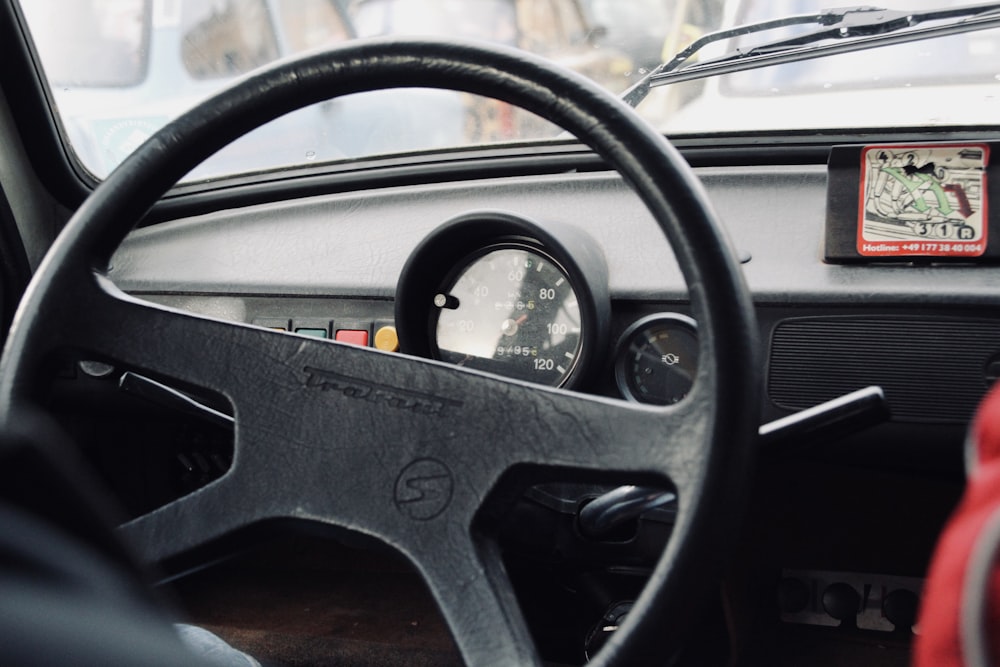 black steering wheel in close up photography