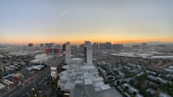 A panoramic view of a hotel exterior glowing under the evening sky.