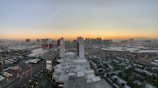 A scenic view of the city skyline from a hotel balcony at sunset.