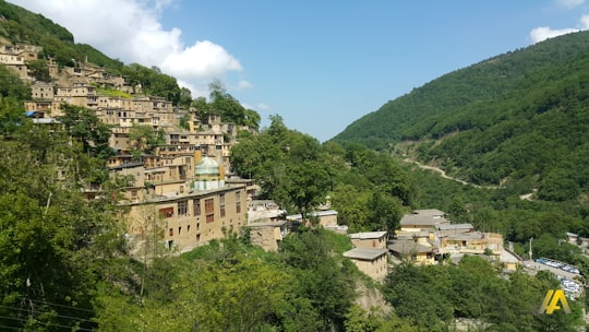 white and brown concrete building on mountain in ماسوله، Gilan Province Iran