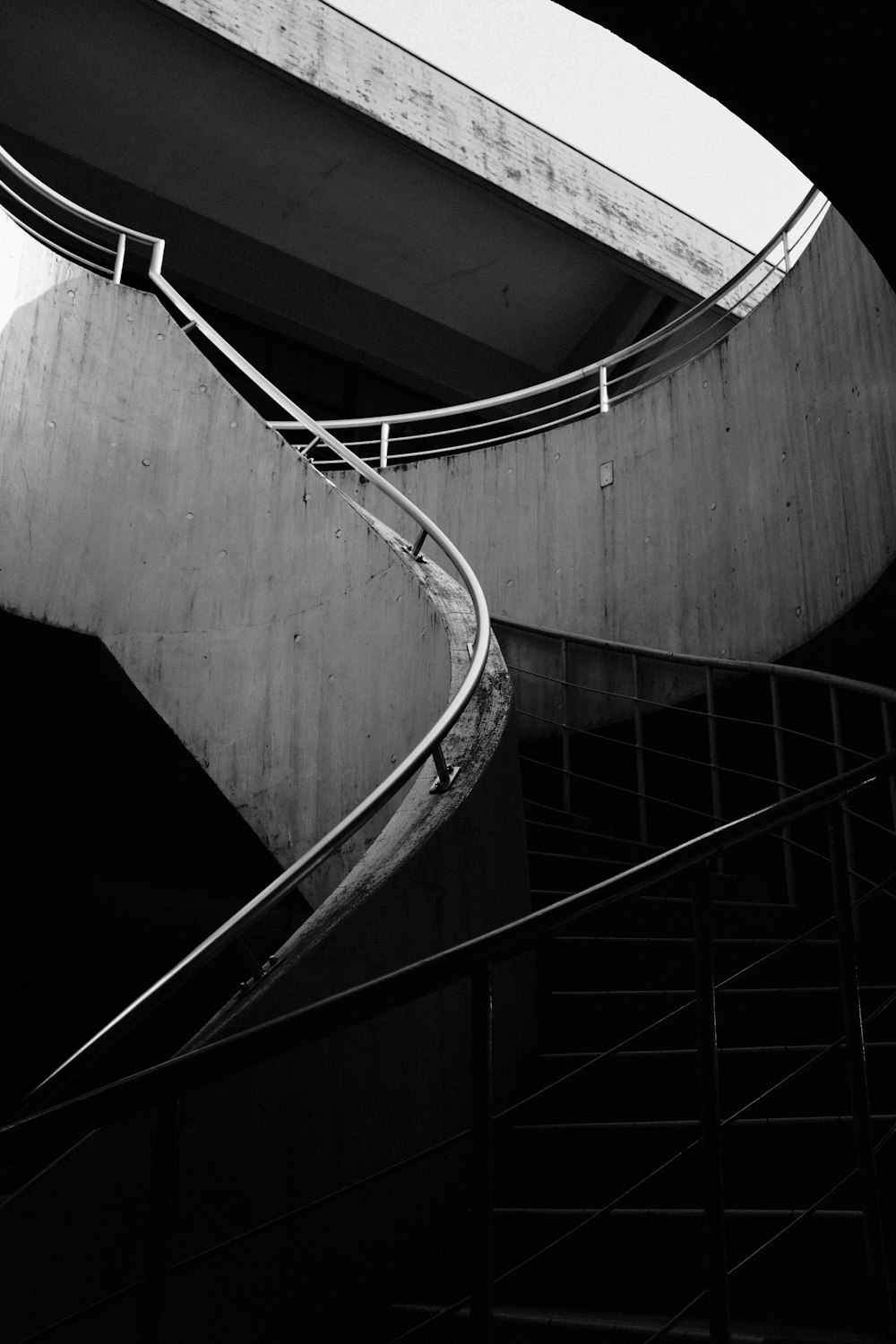 grayscale photo of spiral staircase