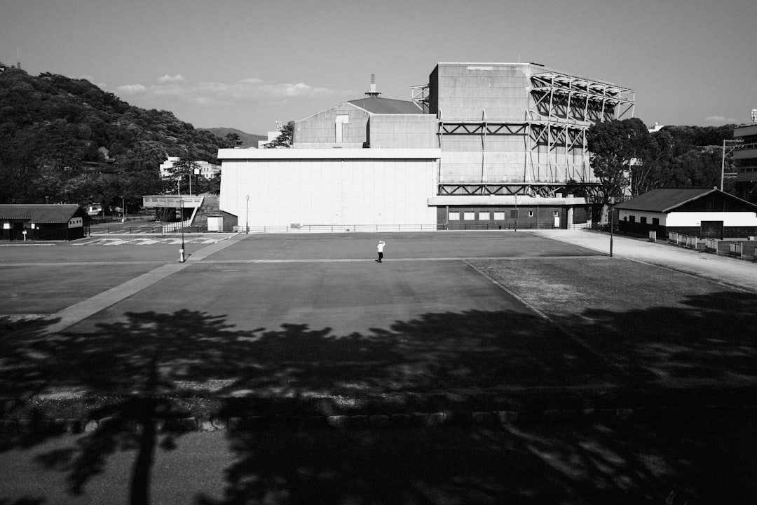 grayscale photo of building near mountain