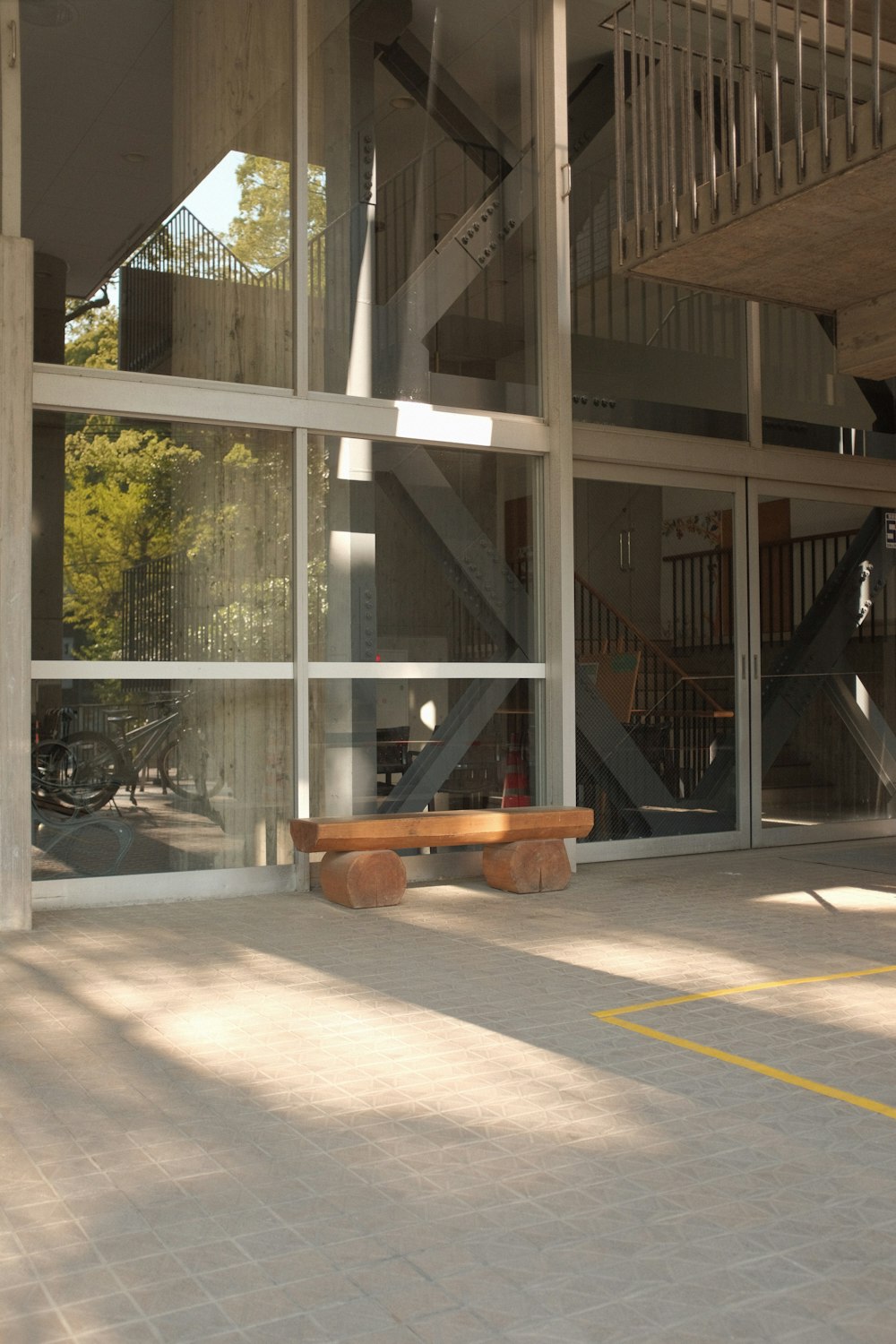 brown wooden bench near glass window