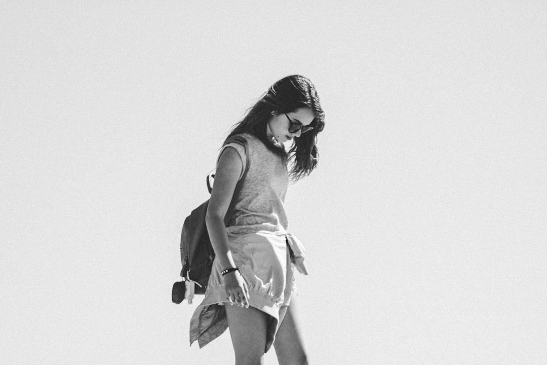 grayscale photo of woman in tank top and skirt