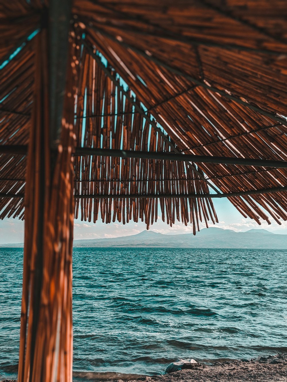 brown wooden roof over the sea during daytime