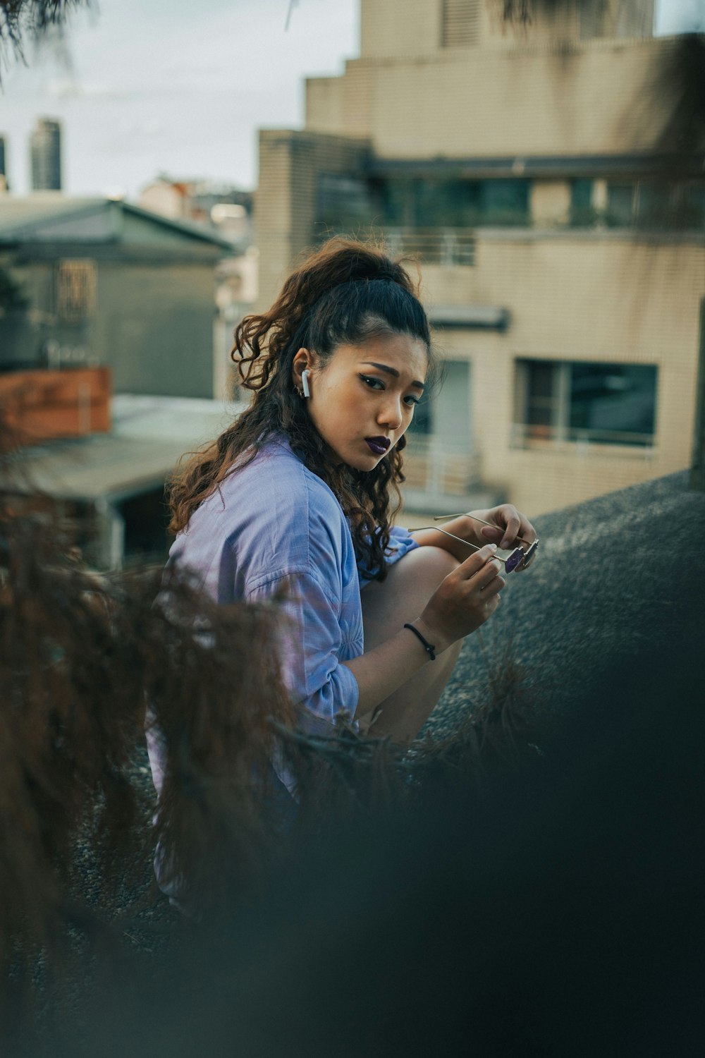 girl in blue shirt sitting on black leather couch