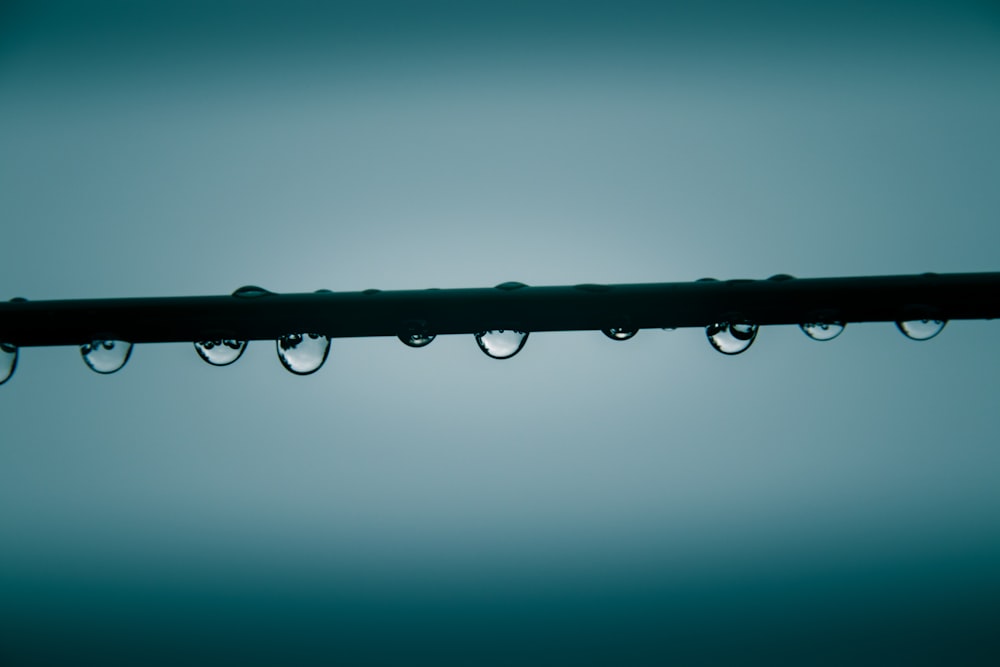 water droplets on black metal bar