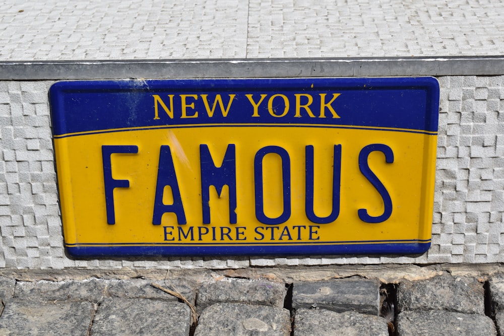 a blue and yellow license plate that says famous