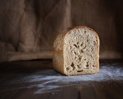 A freshly baked loaf of bread on a wooden table.