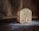 A warm loaf of bread on a rustic wooden table.
