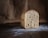 A warm loaf of freshly baked bread resting on a rustic wooden table, surrounded by a few scattered flour dust and baking tools.