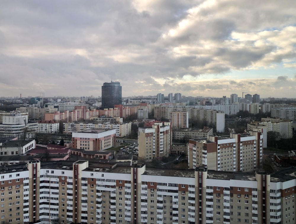 high rise buildings under white clouds during daytime