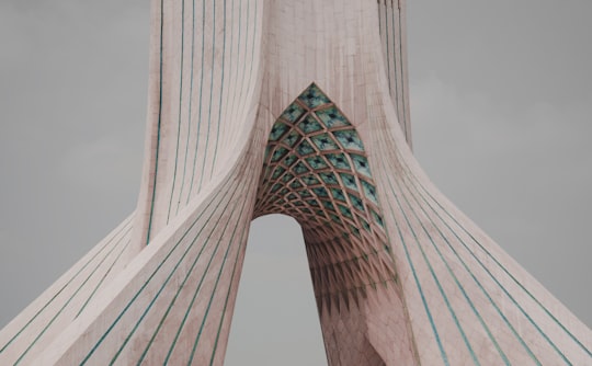 white concrete building under white sky during daytime in Azadi Tower Iran