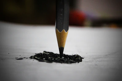 black pencil on white surface