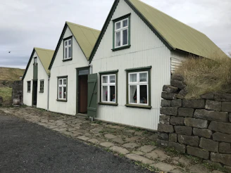 Renovated cozy house exterior blending old charm with new materials.