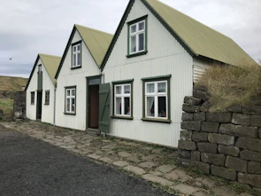 Cozy home exterior featuring natural wood and clean lines under a cloudy sky