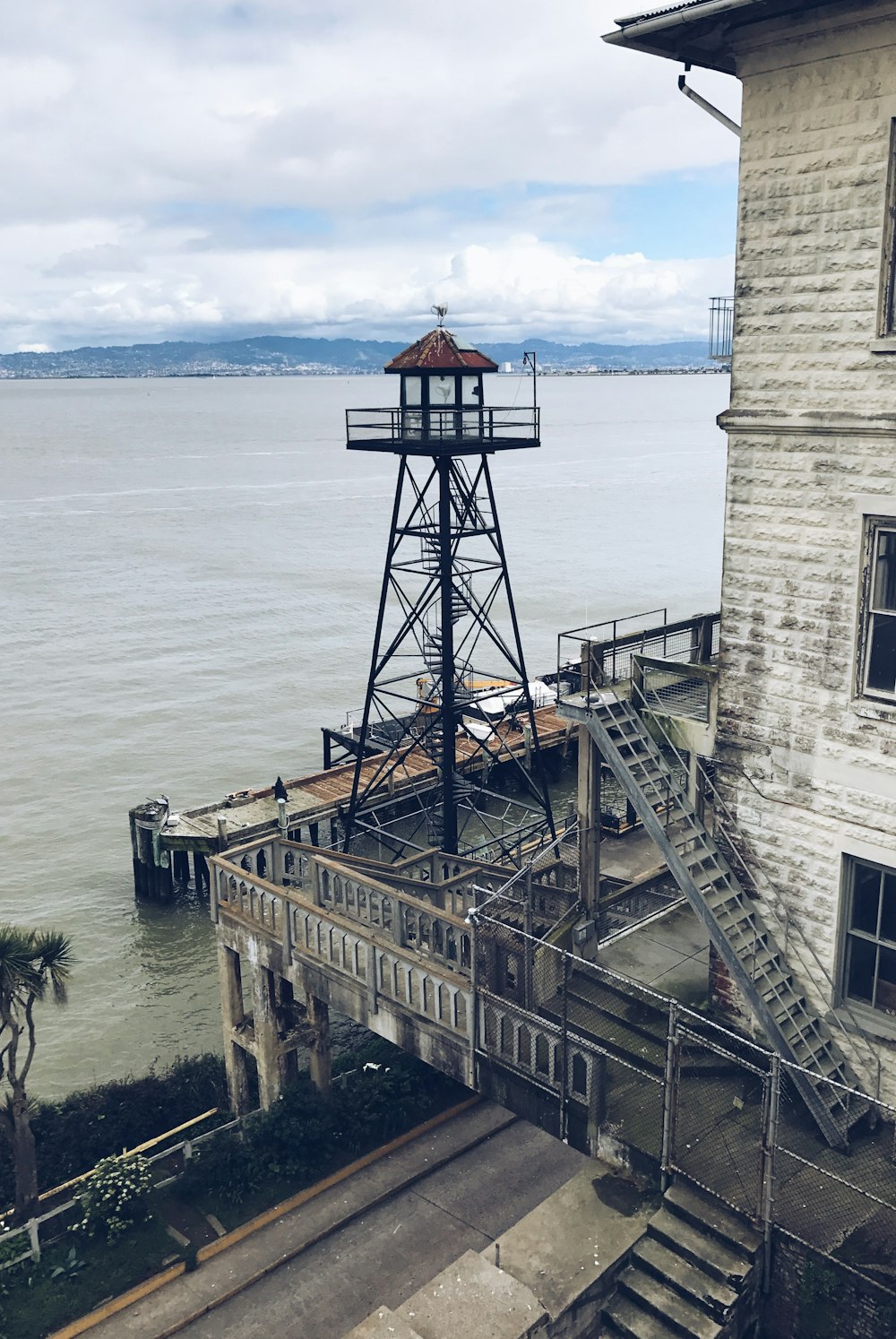 an old building with a tower next to a body of water