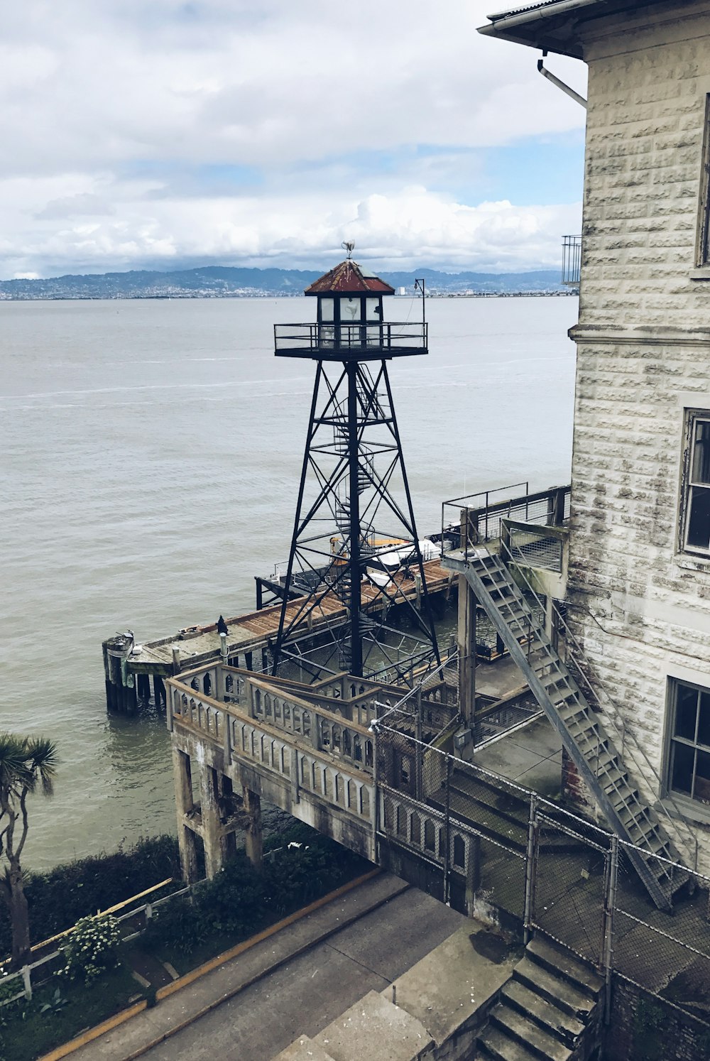 ein altes Gebäude mit einem Turm neben einem Gewässer