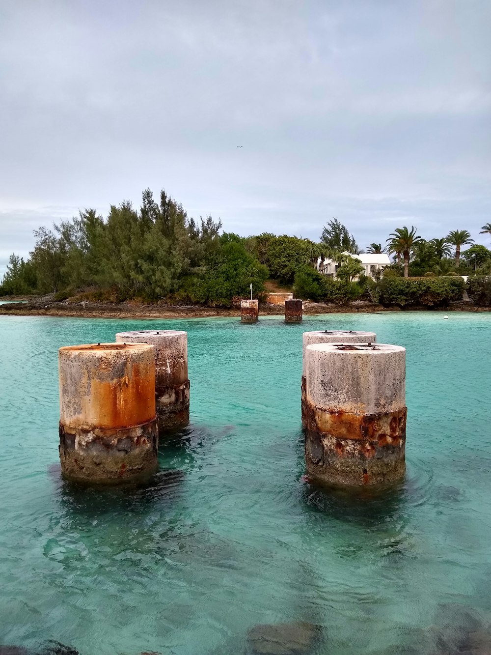 brown and green concrete structure on body of water during daytime