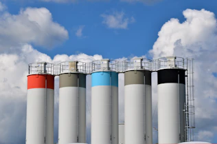 white and blue factory under blue sky during daytime