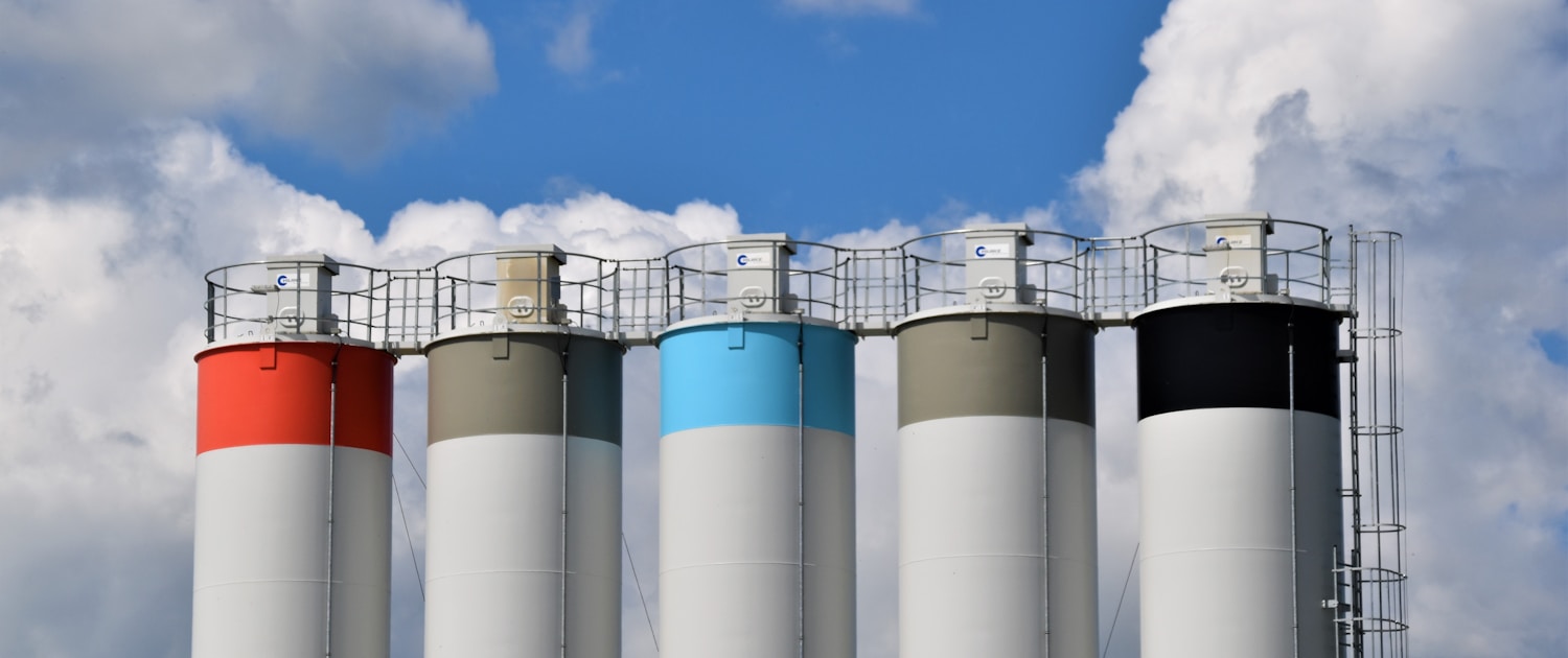 white and blue factory under blue sky during daytime