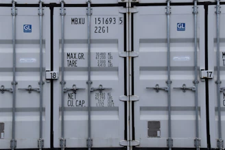 Customs officers inspecting cargo containers with official documents in hand.