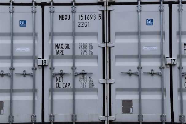 A team of professionals inspecting a shipping container.
