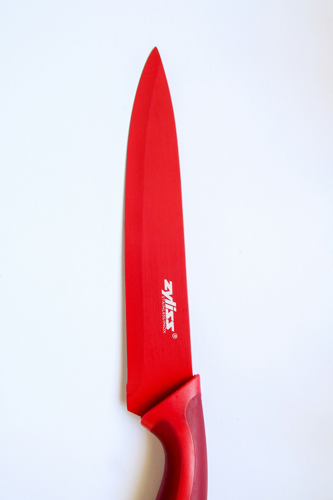 red and gray knife on white surface