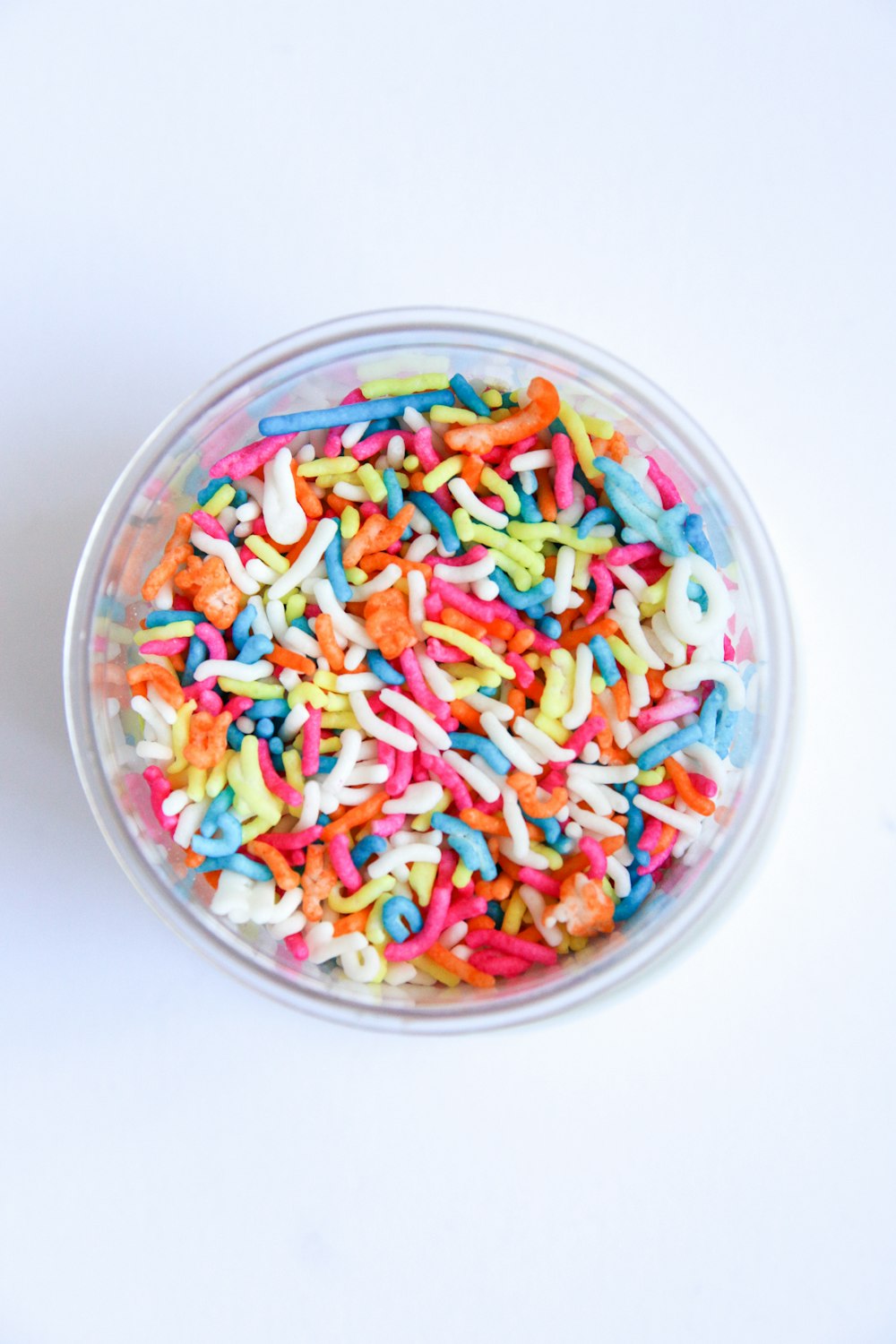 assorted color candies in clear glass bowl