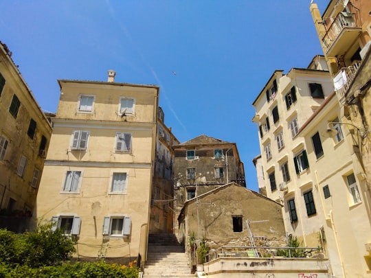 beige concrete building under blue sky during daytime in Corfu Greece